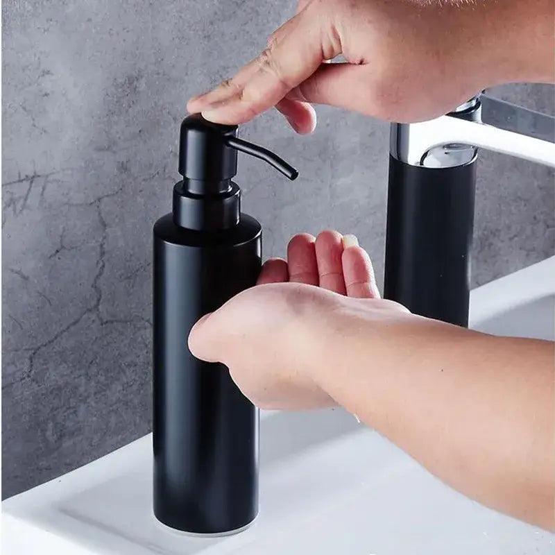 Matte black stainless steel soap dispenser with sleek cylindrical body and modern pump by decorbites for bathroom use