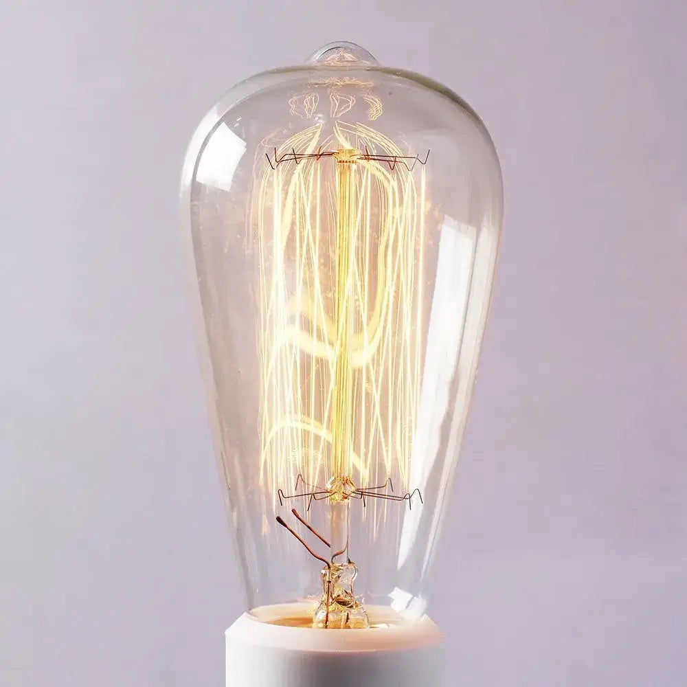 A glowing vintage-style incandescent bulb with intricate filament in decorbites black umbrella wall lights for living room