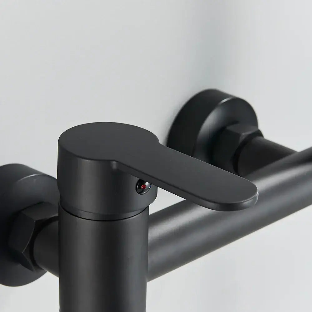 Matte black wall mounted waterfall bathtub faucet with handheld spray featuring a sleek decorbites black wall design