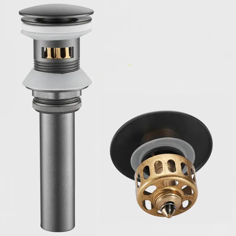 Matte black and brushed gold drain assembly kit featuring a modern cylindrical bathroom sink drain with perforated filter