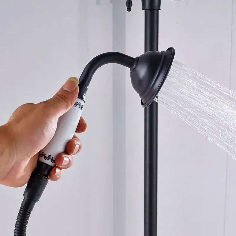 Matte black and white ceramic shower faucet set featuring a black matte shower faucet head with decorative white grip