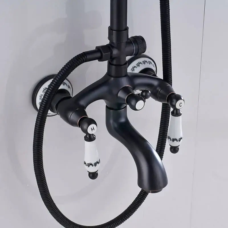 Matte black and white ceramic shower faucet set with black ornate handles labeled h and c for hot and cold water