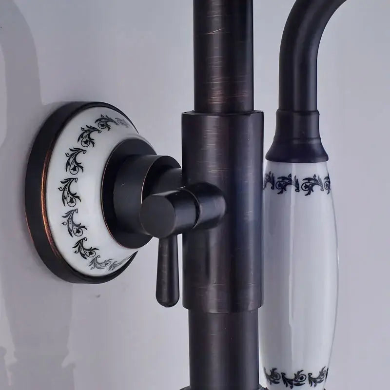 Matte black and white ceramic shower faucet set with black matte brass finish and ornate scrollwork handles for bathroom use