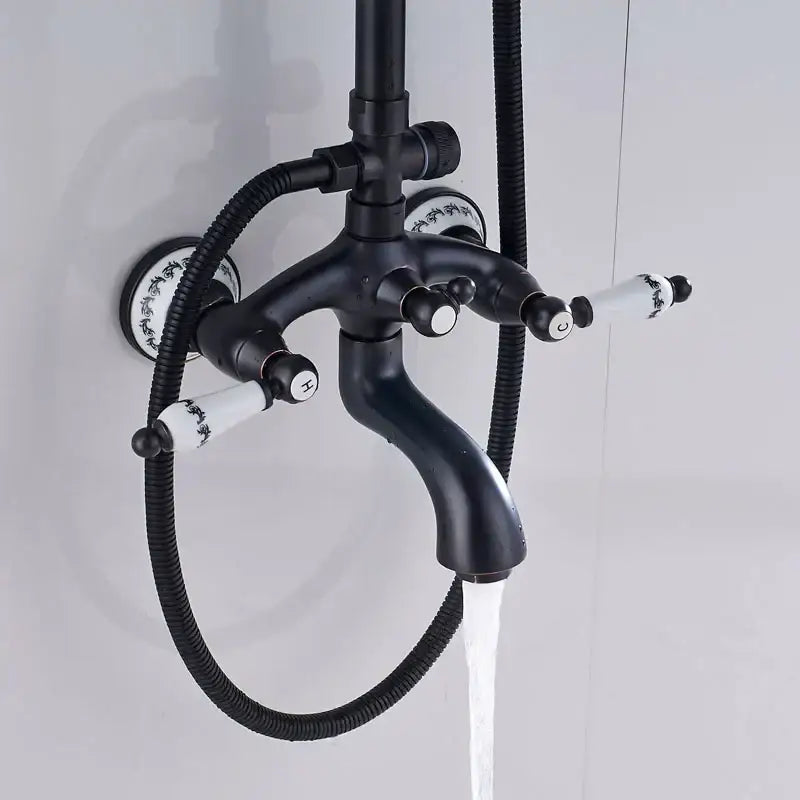 Matte black and white ceramic shower faucet set with black floral handles and curved spout for bathroom rainfall use