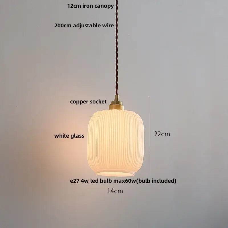 A warm glowing pendant light with white ribbed glass shade and brass copper socket for decorbites ceramic walnut
