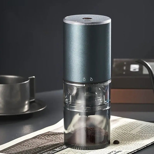 Matte dark teal electric coffee bean grinder with silver accents and transparent chamber for precise grinding