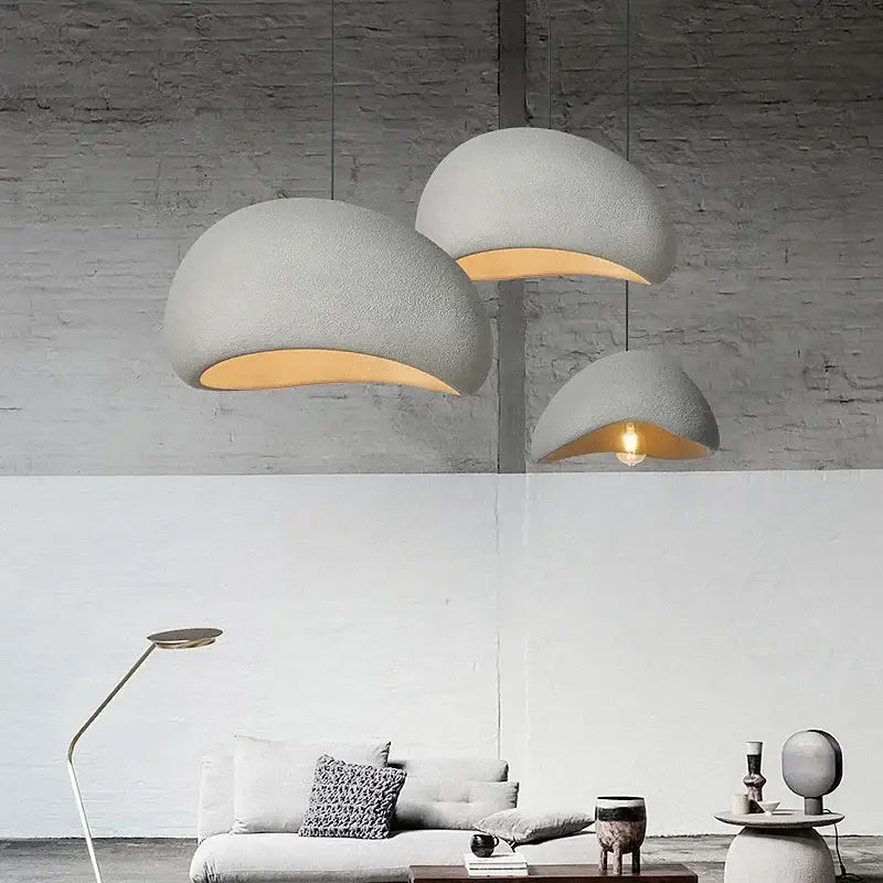 Three matte gray led wabi sabi chandelier pendant lights with textured dome design and warm interior lighting for dining room
