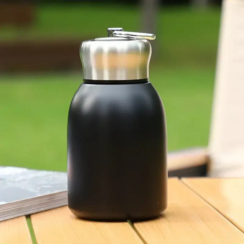 Black matte stainless steel vacuum flask water bottle with silver screw-on lid and flip-top spout for travel use