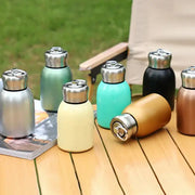 A sleek matte pastel stainless steel vacuum flask with a metallic silver cap for kitchen and travel use