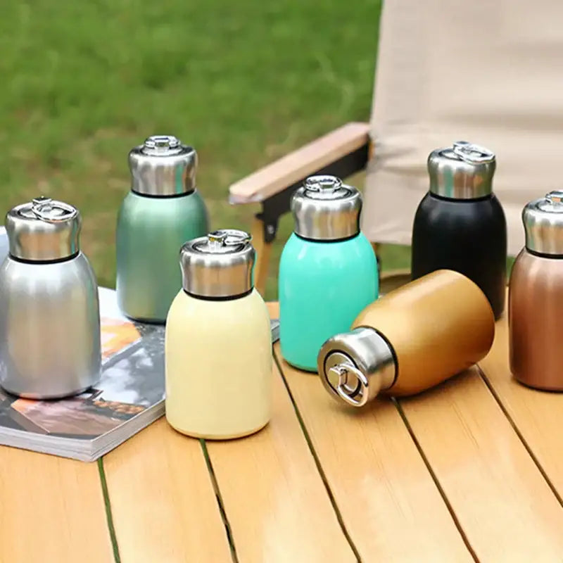 A sleek matte pastel stainless steel vacuum flask with a metallic silver cap for kitchen and travel use