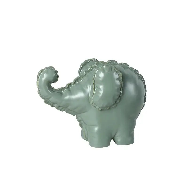 A glossy sage green ceramic elephant abstract bubble sculpture with textured ruffled ears for home decor by decorbites elephant abstract