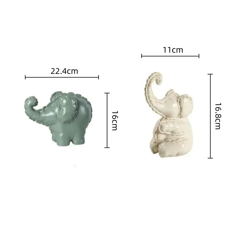 Two ceramic elephant figurines in matte sage green and off-white with decorative detailing for home decor