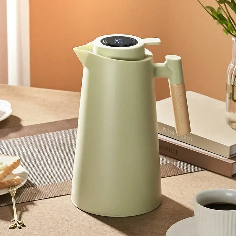 A matte sage green decorbites insulation kettle thermos bottle with a digital temperature display and wooden handle
