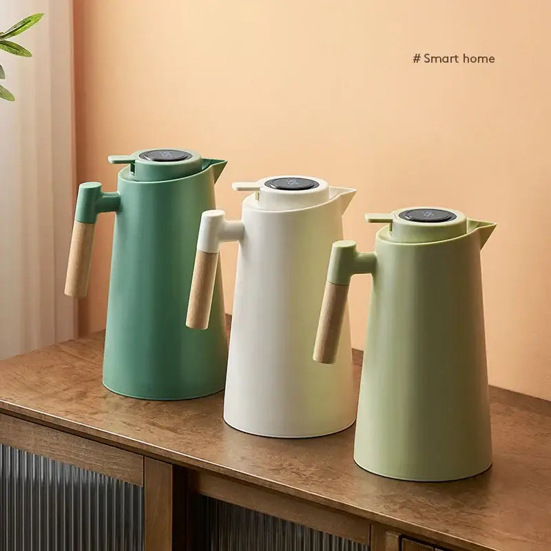 Three modern matte sage green, mint, and off-white decorbites insulation kettles with wooden handles and black digital lids thermos bottle