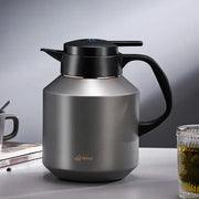 A sleek matte stainless steel decorbites insulation pot with black lid and handle for kitchen use