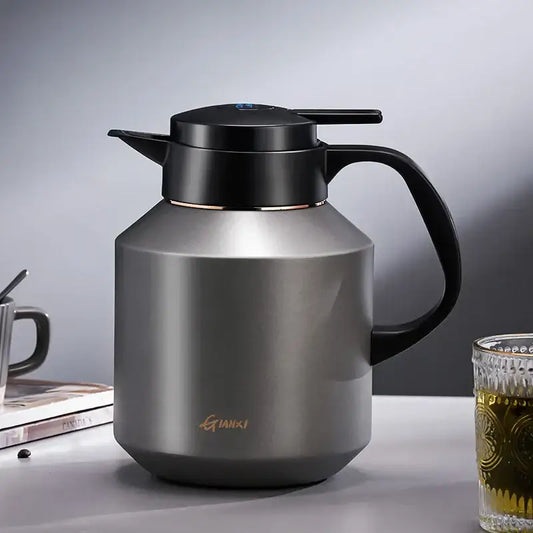 A sleek matte stainless steel decorbites insulation pot with black lid and handle for kitchen use