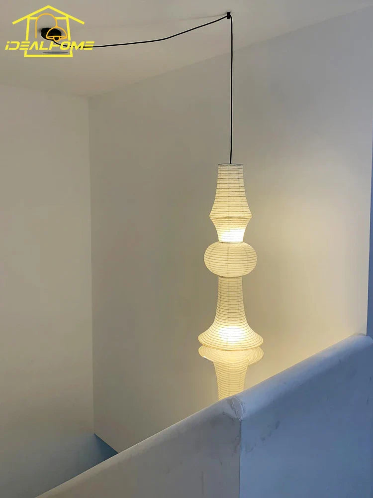 A warm cream-colored tiered akari noguchi yong rice paper pendant light suitable for home decor and staircases