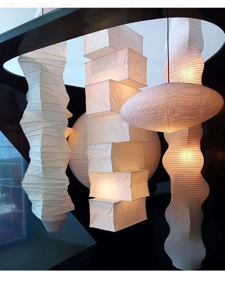 A collection of elegant cream-colored akari noguchi yong pendant lights with pleated rice paper texture for home decor