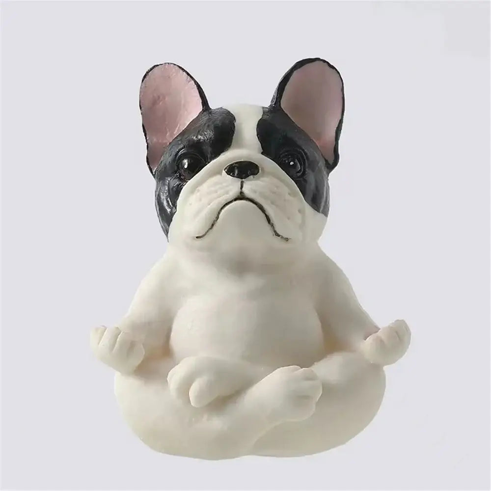 A black and white meditative bulldog resin statue with pink ears from decorbites bulldog resin garden decor set