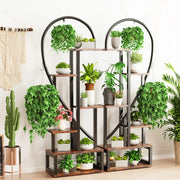 Decorbites 6-tier half heart metal plant stand in black metal and wood with multiple shelves holding potted plants