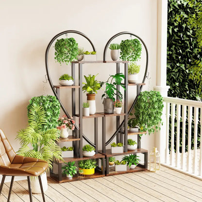 Decorbites 6-tier half heart metal plant stand with wooden shelves and hanging hooks holding white ceramic pots