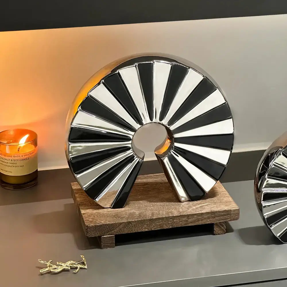 Shiny black and silver segmented metallic chrome geometric ceramic fan ornament on wooden base for living room decorbites decor