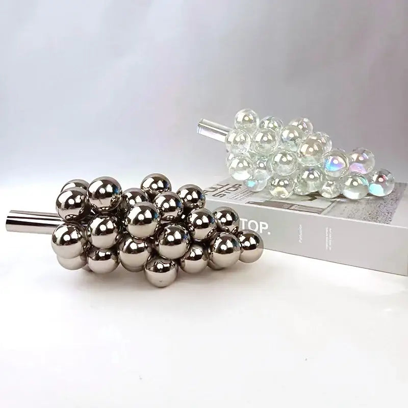 Shiny metallic glass geometric grape sculpture featuring crystal glass for elegant dining room decor by decorbites