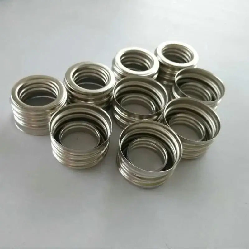 Stacks of silver metallic threaded e40 lamp holder adapters for garage workshop lighting applications