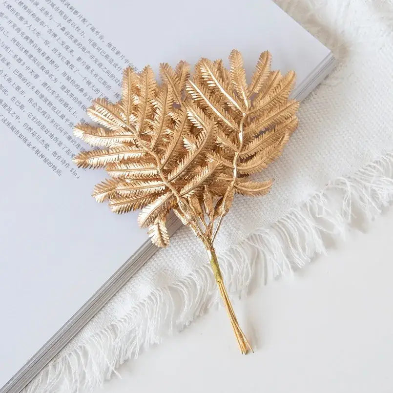 Gold metallic palm leaves brooch with intricate leaf detailing and slender stem for decorbites gold palm decorbites gold palm leaves decor