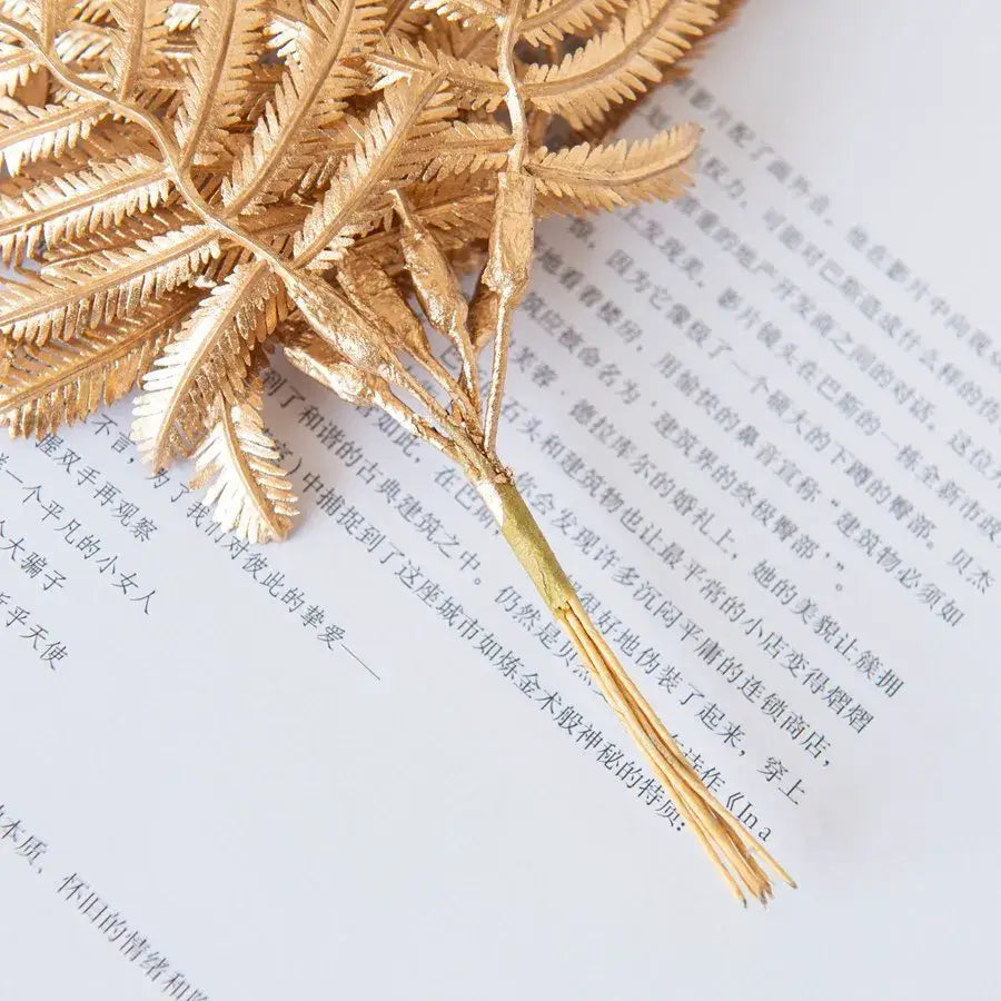 Gold metallic palm leaf brooch with intricate fronds and delicate stem for decorbites gold palm living room decor
