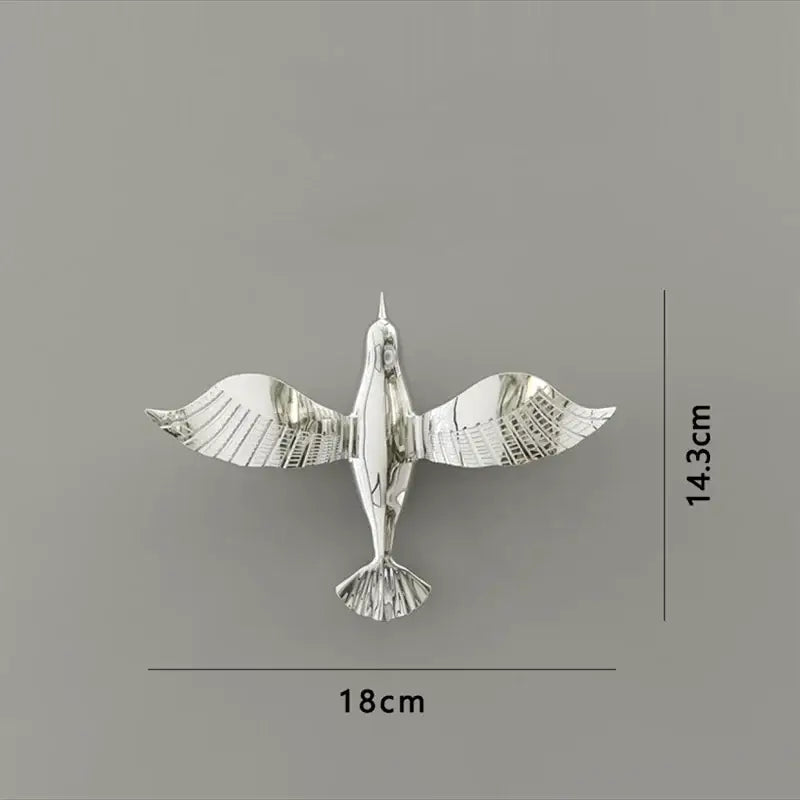 Silver metallic pigeon wall decor with detailed feathers and minimalist design for living room dove statue display