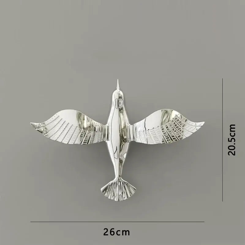 Silver metallic pigeon wall decor with detailed wing and tail feathers perfect for living room dove statue display