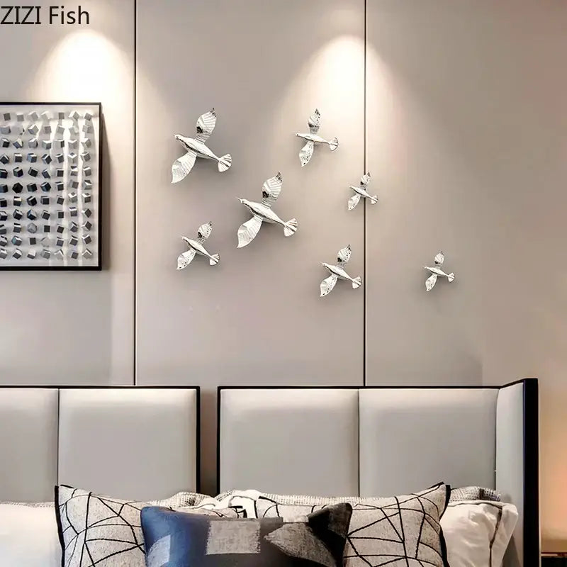 Silver metallic pigeon wall sculptures featuring a dove statue design for living room decoration