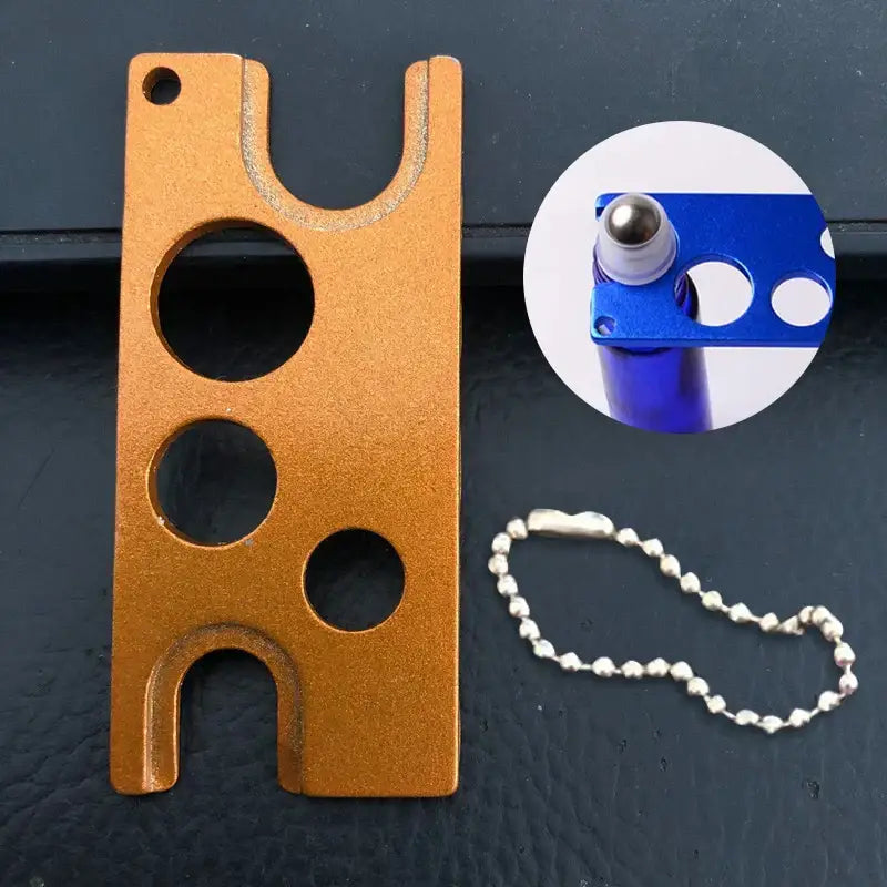 Orange metallic essential oils opener tool with circular and u-shaped cutouts for decorbites essential oils storage