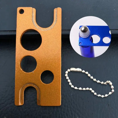 Orange metallic essential oils opener tool with circular and u-shaped cutouts for decorbites essential oils storage