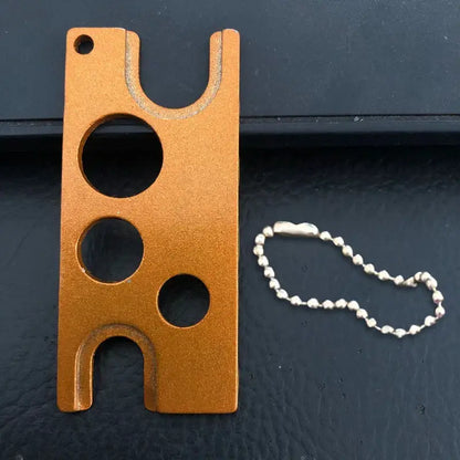 Orange aluminum essential oils opener tool with three circular cutouts and silver ball chain for decorbites essential oils storage