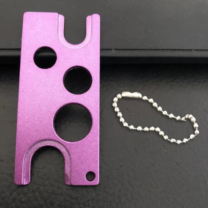 Purple metallic essential oils opener tool with three circular cutouts and silver ball chain for kitchen storage decorbites essential oils