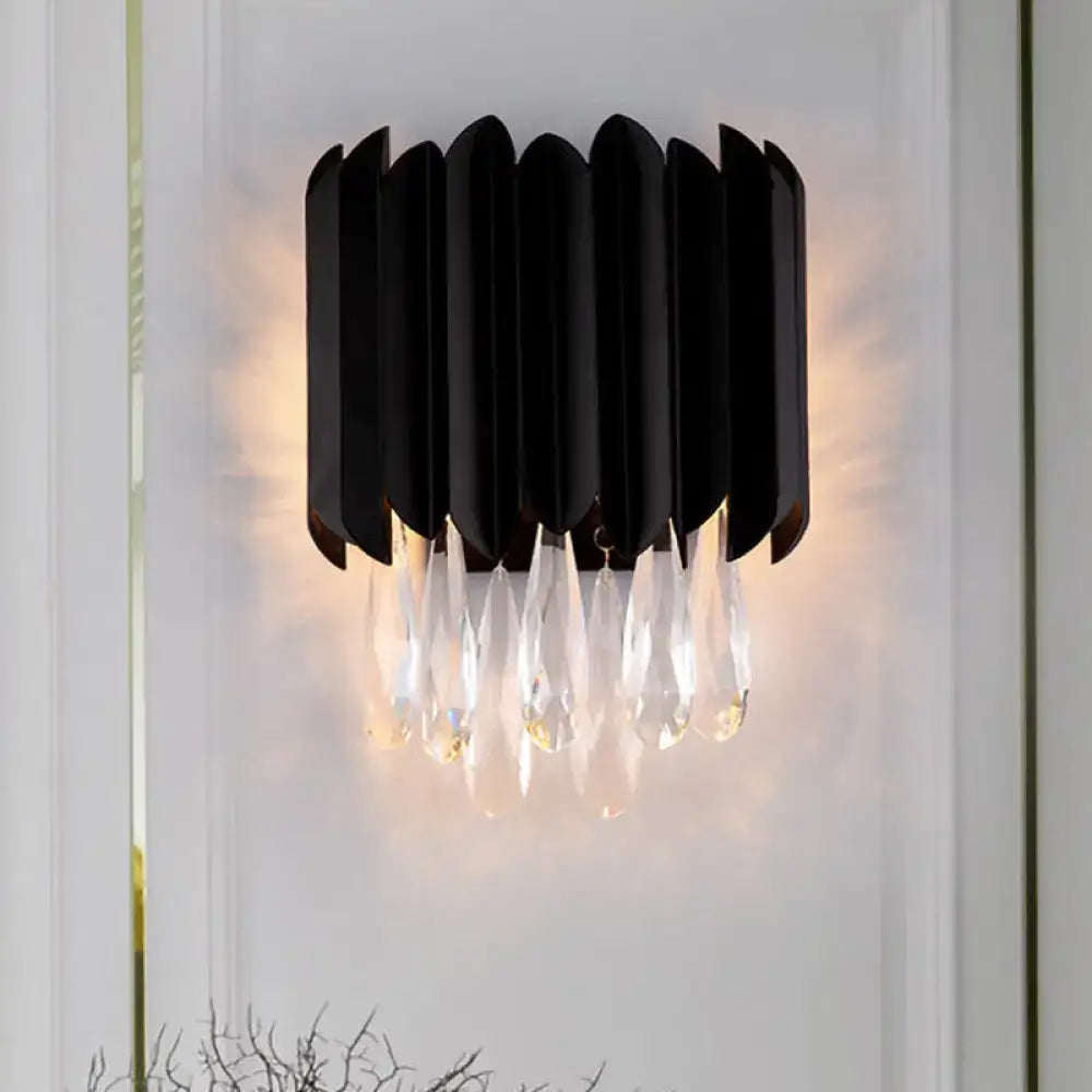 Mid century black metal wall sconce with cascading crystal droplets designed for e12 light bulb in bedroom use