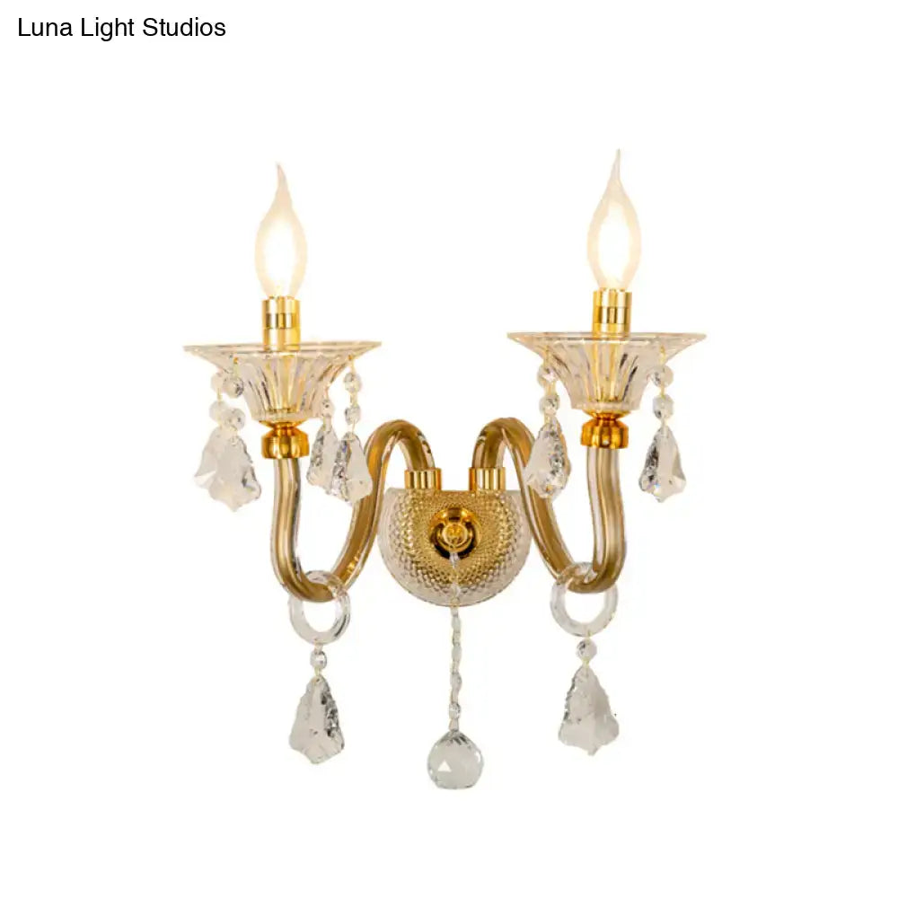 Mid-century brass crystal shade wall mounted sconce with gold-toned crystal chandelier and two candle-style bulbs