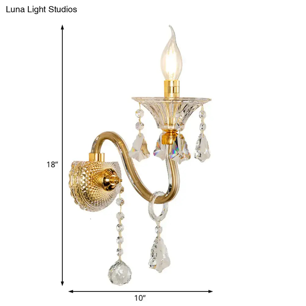 Gold-toned mid-century brass crystal shade wall mounted sconce with faceted crystals and teardrop pendants for bedroom lighting
