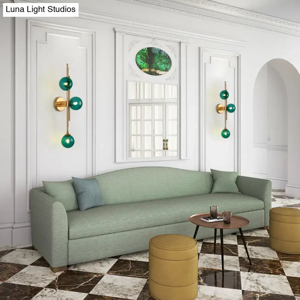 Mid century 3 light clear green glass orb sconce with brass finish and fixture height for living room lighting