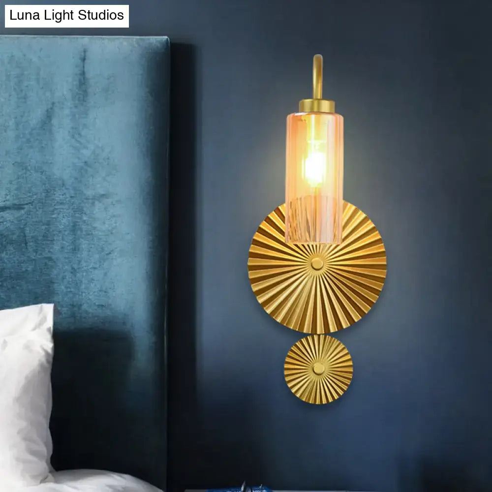 Mid century brass gooseneck wall lamp with gold-toned sunburst discs and amber glass shade for bedroom use