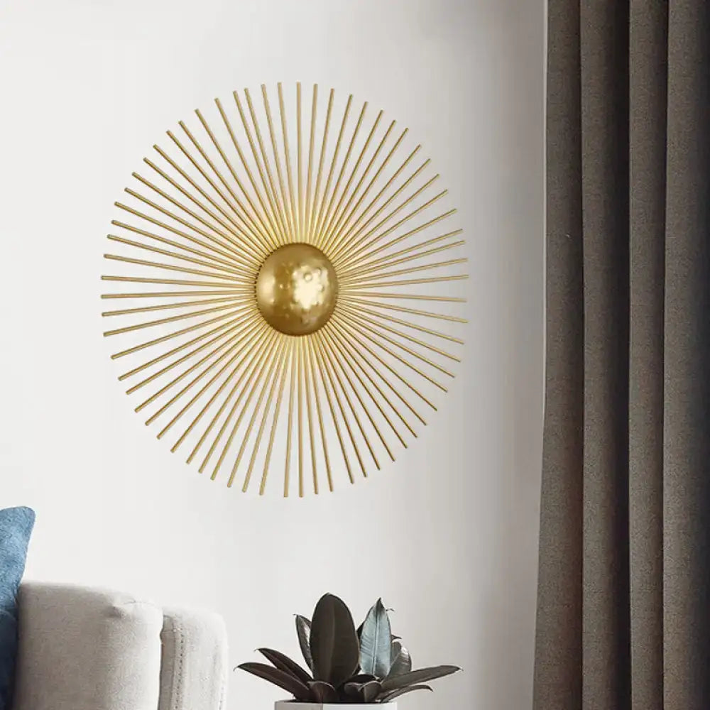 Mid century brass sunburst sconce light fixture with gold metal rays and central orb for living room wall decor