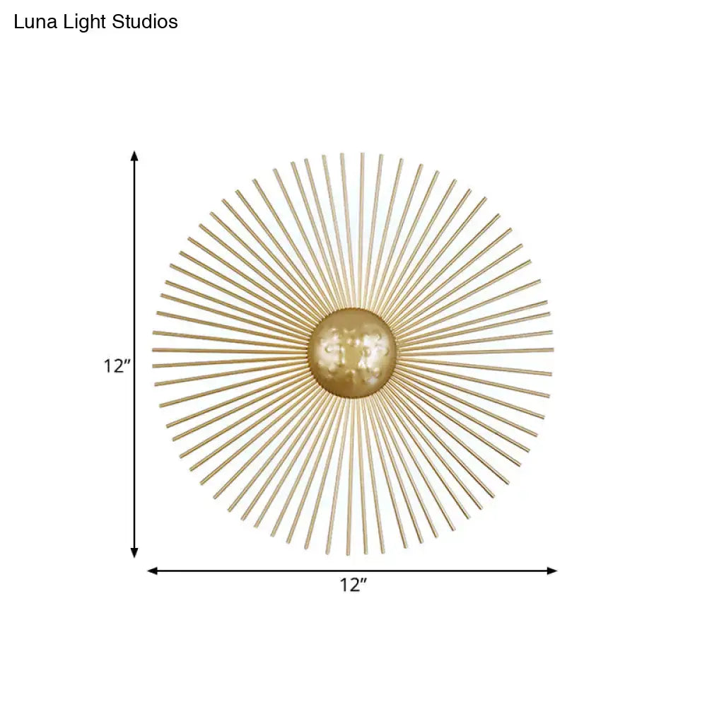Mid century brass sunburst sconce light fixture with gold-toned metal spokes and central orb for living room wall use