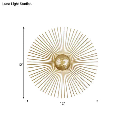 Mid century brass sunburst sconce light fixture with gold-toned metal spokes and central orb for living room wall use
