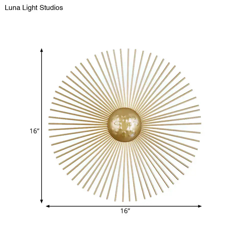 Mid century brass sunburst sconce light fixture with gold-toned metal orb and radiating spokes for living room wall