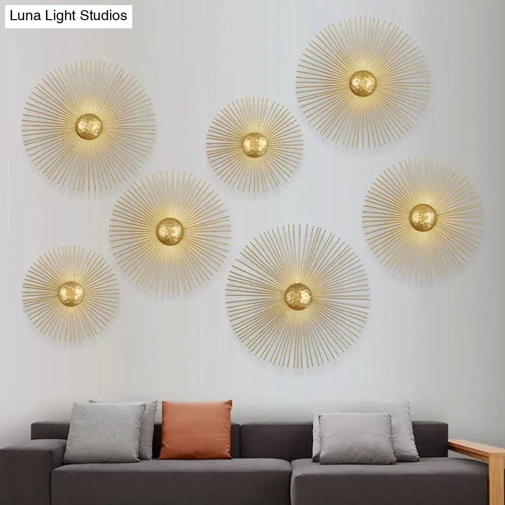 Mid century brass sunburst sconce light fixture with gold metallic radial spokes and central spherical accents for living room wall