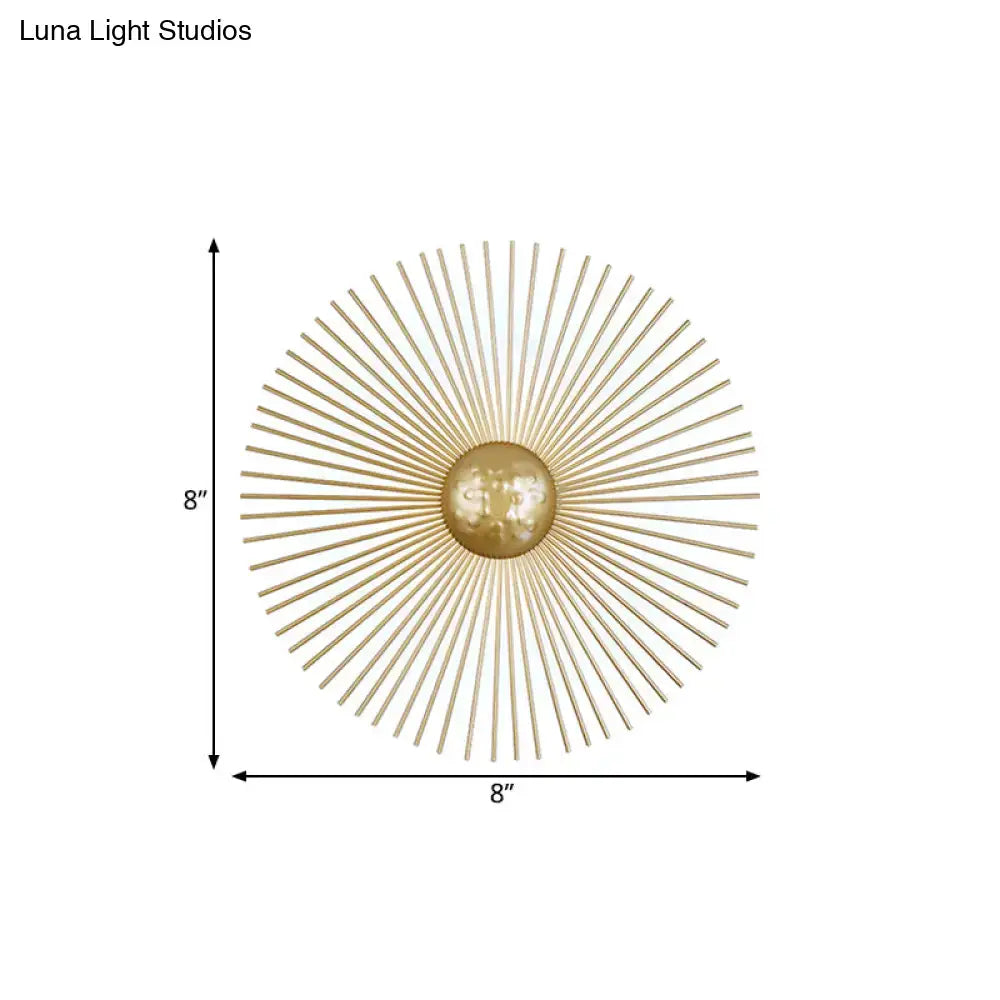 Mid century brass sunburst sconce light fixture features gold-toned metal with radiating spokes and a central orb