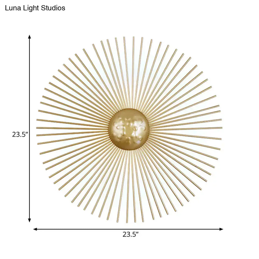 Mid century brass sunburst sconce light fixture with gold-toned metal orb and radiating spokes for living room wall use