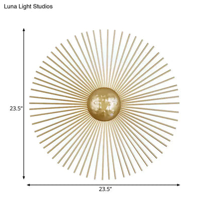Mid century brass sunburst sconce light fixture with gold-toned metal orb and radiating spokes for living room wall use